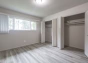 Thumbnail 8 of 18 - an empty bedroom with a large window and a closet