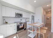 Thumbnail 1 of 40 - a kitchen or kitchenette at olympic view london stratford apartment at Brookland Apartments, Portland, OR 97202