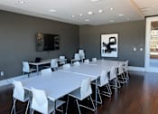 Thumbnail 23 of 78 - A conference room with a long table and chairs.