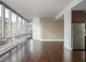 Thumbnail 66 of 78 - A large empty room with a refrigerator in it.