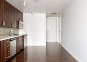 Thumbnail 68 of 78 - A kitchen with wooden cabinets and a white counter top.