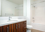 Thumbnail 49 of 78 - A white bathroom with a sink, toilet, and bathtub.