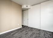 Thumbnail 53 of 78 - A room with a carpeted floor and a white door.