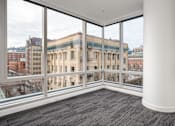 Thumbnail 50 of 78 - A large room with a view of a cityscape through the windows.