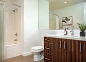 Thumbnail 7 of 36 - A bathroom with a toilet, sink, and shower.