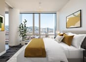 Thumbnail 5 of 36 - A bedroom with a large bed and a view of the city.