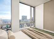 Thumbnail 69 of 78 - A room with a large window overlooking a cityscape.