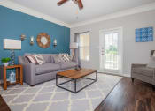 Thumbnail 26 of 31 - a living room with a couch and a coffee table at Carrington Place at Wildewood, South Carolina, 29223