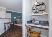 Thumbnail 23 of 31 - a living room with a bar and a kitchen with a table and chairs at Carrington Place at Wildewood, Columbia, 29223  