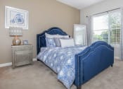 Thumbnail 21 of 31 - a bedroom with a bed and a window at Carrington Place at Wildewood, Columbia, SC 29223  
