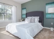 Thumbnail 22 of 31 - a bedroom with a large bed and a window at Carrington Place at Wildewood, Columbia  