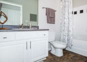 Thumbnail 31 of 31 - a bathroom with a toilet and a sink and a shower at Carrington Place at Wildewood, Columbia South Carolina   