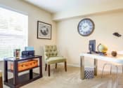 Thumbnail 9 of 17 - a home office with a large clock on the wall at The Bristol Apartments, Greenville