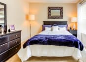 Thumbnail 11 of 17 - a bedroom with a large bed and a window with blinds at The Bristol Apartments, Greenville