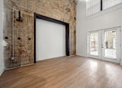 Thumbnail 10 of 25 - A room with a white door and a window with blinds.