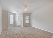Thumbnail 3 of 23 - A room with a ceiling fan and carpeted floor.