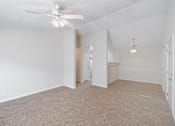 Thumbnail 4 of 23 - A room with a ceiling fan and carpeted floor.