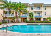 Thumbnail 1 of 6 - a large swimming pool in front of an apartment building