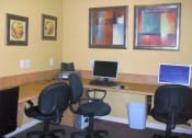 Thumbnail 6 of 7 - an office with a desk with a computer and chairs