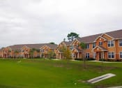 Thumbnail 3 of 7 - a row of houses on a lush green field