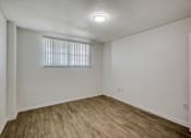Thumbnail 13 of 23 - a bedroom with white walls and a window