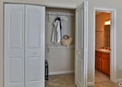Thumbnail 14 of 17 - A white closet with a towel hanging on a hanger at The Bristol Apartments, Greenville