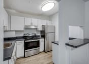 Thumbnail 11 of 23 - a kitchen with white cabinetry and stainless steel appliances