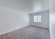 Thumbnail 9 of 10 - a living room with white walls and a window at Carolina Springs Apartments, 27510  