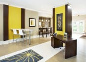 Thumbnail 7 of 17 - a room with a desk and chairs in it and a kitchen in the background at The Bristol Apartments, South Carolina