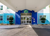 Thumbnail 20 of 21 - The entrance to a building with a blue and white color scheme.