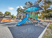 Thumbnail 15 of 19 - A playground with a blue slide and a blue canopy.