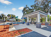 Thumbnail 12 of 19 - A bus stop shelter is located in a park with a bench and a bike rack.