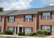 Thumbnail 10 of 13 - a red brick house with a sidewalk in front of it