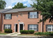 Thumbnail 3 of 13 - a brick house with a sidewalk in front of it