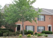 Thumbnail 2 of 13 - the front of a brick house with a tree in the yard