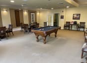Thumbnail 3 of 6 - a game room with a pool table in the middle