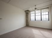 Thumbnail 6 of 18 - an empty bedroom with a large window and a ceiling fan
