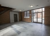 Thumbnail 18 of 18 - an empty room with a large glass door and a brick wall