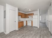 Thumbnail 14 of 26 - Kitchen with white appliances and wooden cabinets at Greens of Concord, Concord, NC, North Carolina, 28025