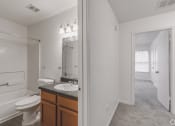 Thumbnail 20 of 26 - a bathroom with a toilet and a sink and a mirror at Greens of Concord, Concord, NC, North Carolina