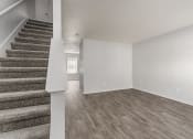 Thumbnail 8 of 26 - Living room and staircase of a renovated house and wood flooring at Greens of Concord, North Carolina, 28025