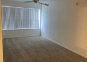 Thumbnail 8 of 15 - an empty room with a ceiling fan and a window