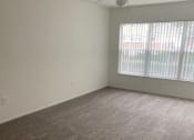 Thumbnail 5 of 15 - an empty living room with a large window