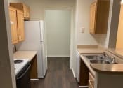 Thumbnail 4 of 15 - a small kitchen with a sink and a refrigerator