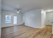 Thumbnail 5 of 23 - A room with wooden floors and a ceiling fan.