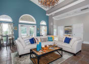 Thumbnail 19 of 31 - a living room with a couch and a coffee table at Carrington Place at Wildewood, South Carolina, 29223