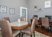 Thumbnail 14 of 31 - a dining room with a table and chairs and a television at Carrington Place at Wildewood, South Carolina   