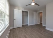 Thumbnail 8 of 23 - A room with a ceiling fan and wooden flooring at Dunean Creek Apartments, Greenville, 29611