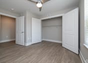 Thumbnail 18 of 23 - A room with a ceiling fan and three white doors at Dunean Creek Apartments, Greenville, South Carolina