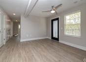 Thumbnail 6 of 23 - A room with a ceiling fan and wooden flooring at Dunean Creek Apartments, Greenville